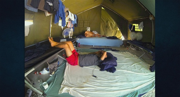 Picture of asylum seeker lying down in tent in Nauru