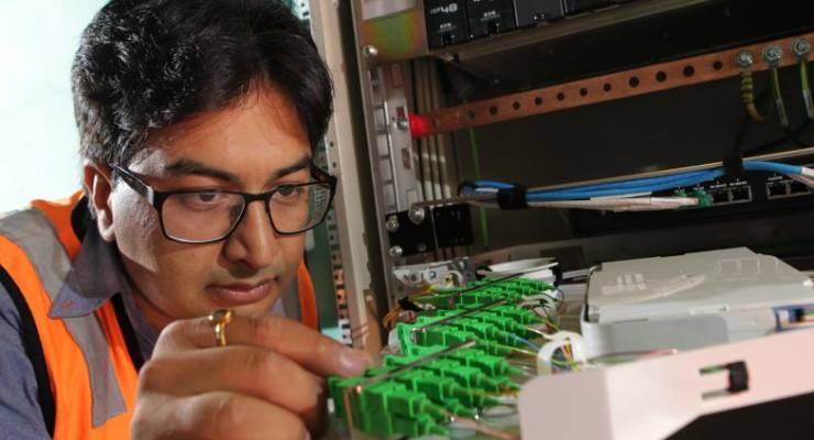 NBN technician Rajav Kapil connecting an apartment block to the National Broadband Network (NBN) in Brunswick, Melbourne, Tuesday, March 11, 2014. (AAP Image/David Crosling)