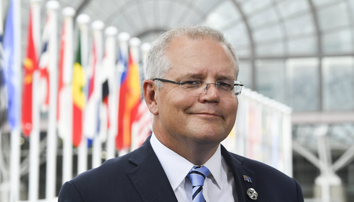 scott-morrison-stands-with-flags