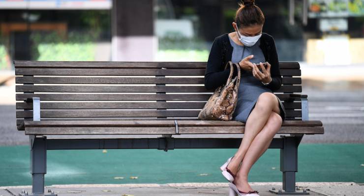 woman-sitting-on-bench-with-mask