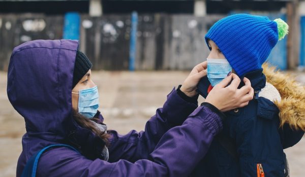 mother-putting-facemask-on-daugher