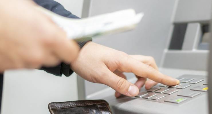 Person takes money out of ATM