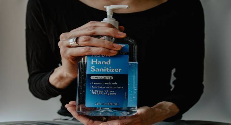 woman-holding-hand-sanitizer