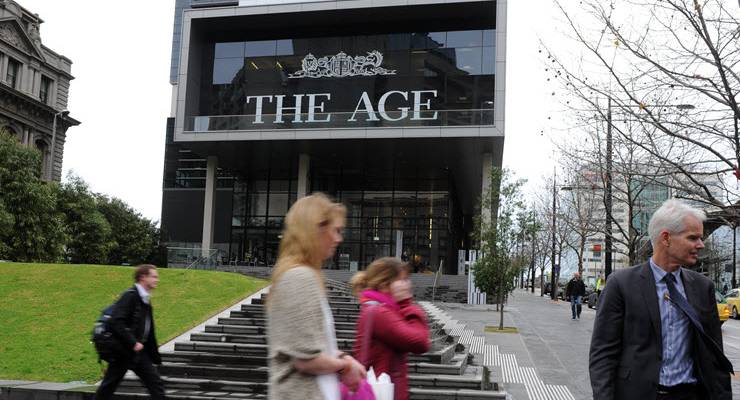 people walk past the age building
