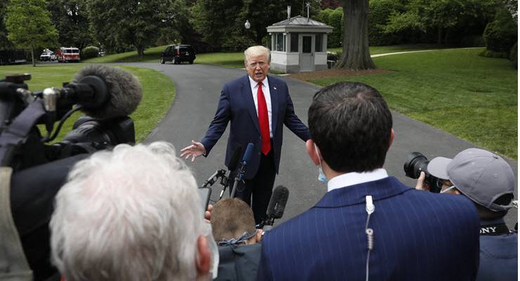 donald trump speaks to a group of reporters