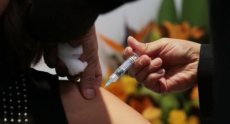 close up of woman receiving flu vaccine injection