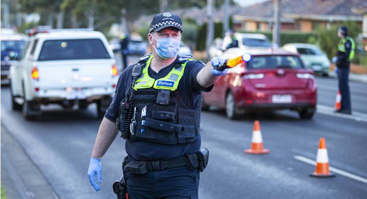 police officer wearing mask directing traffic