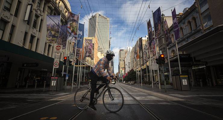 Cyclist wearing mask on tram tracks