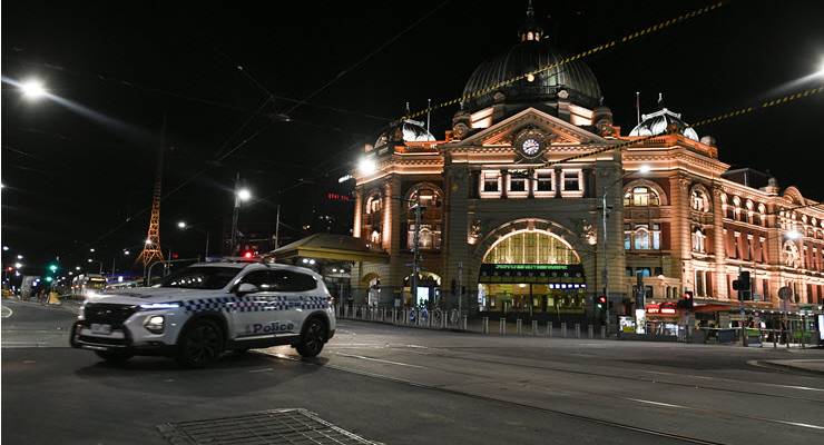 police car outside flinders station at night fine