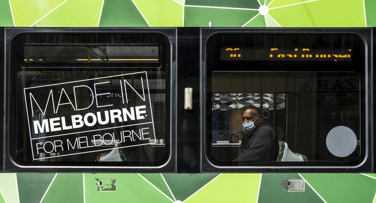 man on tram wearing face mask
