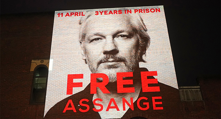 An image of Julian Assange is projected onto a building in London, to mark three years since his arrest and detention in Belmarsh Prison (Image: AAP/Victoria Jones)