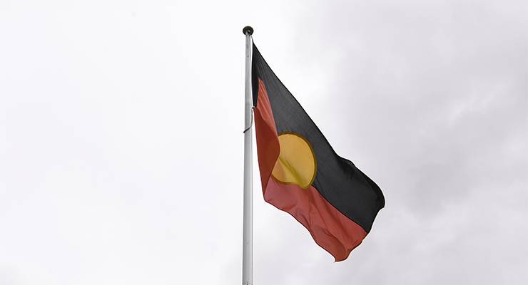 The Aboriginal flag seen in Canberra, 2022 (Image: AAP/Lukas Coch)