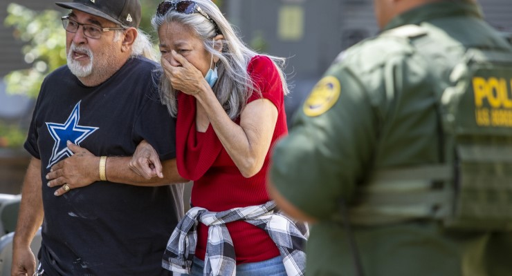 A man and woman leave the Uvalde Civic Center following a mass shooting (Image: AAP/AP/William Luther)