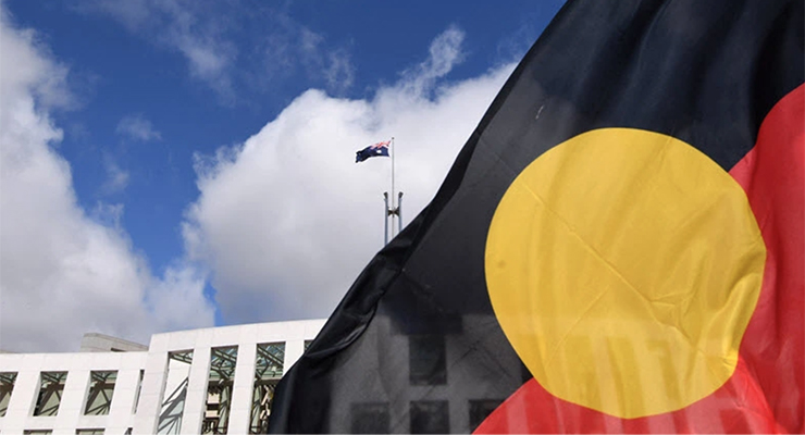 Indigenous flag outside Parliament House (Image: AAP/Lukas Coch)