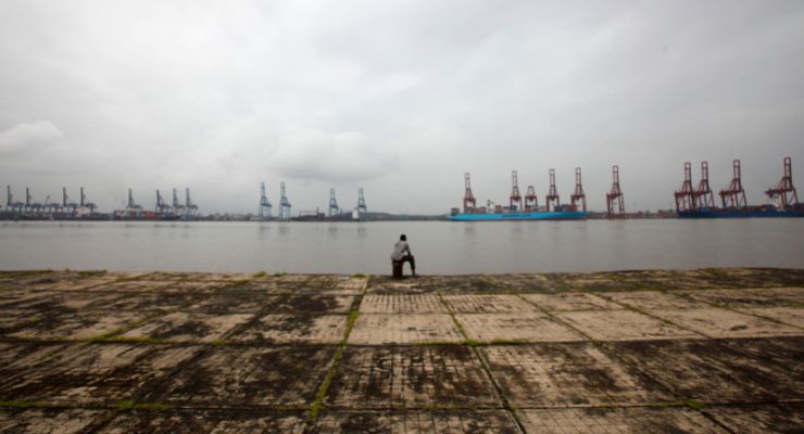 A man opposite the Jawaharlal Nehru Port, Mumbai, India (Image: AAP/Reuters/Danish Siddiqui)