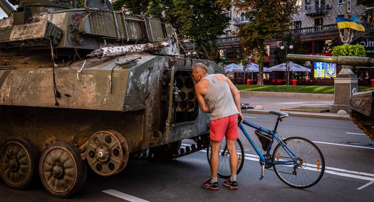 A man observes the interior of a demolished Russian tank in Kyiv (Image: AAP/Alex Chan Tsz Yuk/SOPA/Sipa USA)
