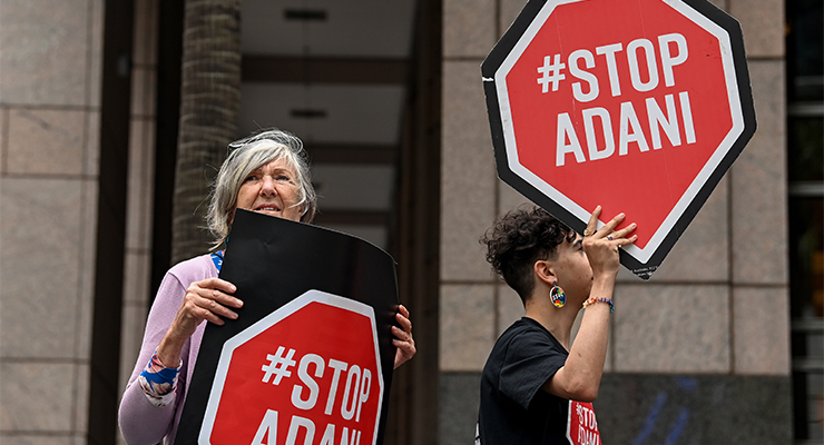 Protesters holding 'Stop Adani' placards (Image: AAP/Bianca De Marchi)