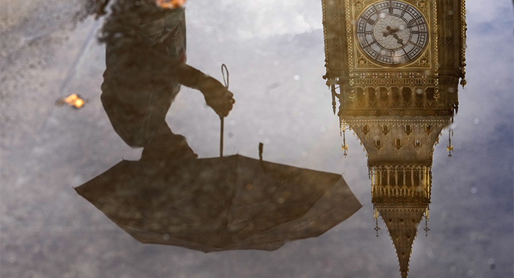 A reflection of a woman and Big Ben in London (Image: AAP/AP/Frank Augstein)