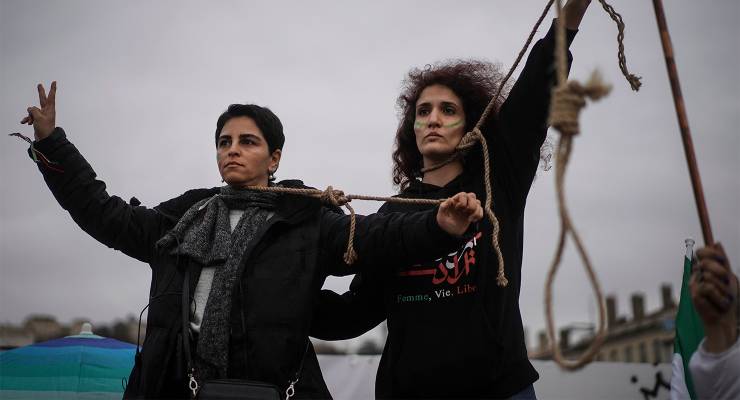 Women pose with ropes around their necks in France in solidarity with nationwide protests in Iran (Image: AAP/AP/Laurent Cipriani)