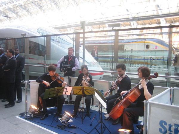 800px-Db-ice-st-pancras-2010-09-20-string-quartet Deutsche Bahn's musical entertainment at the ICE presentation.Public domain
