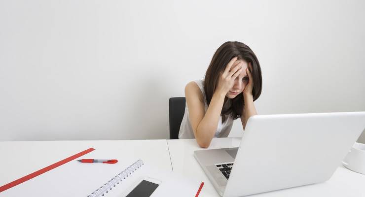 Exhausted woman at keyboard