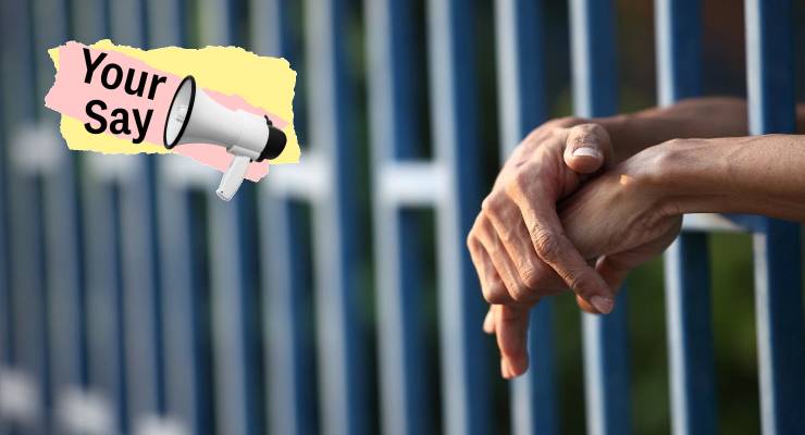 Hands in cell bars