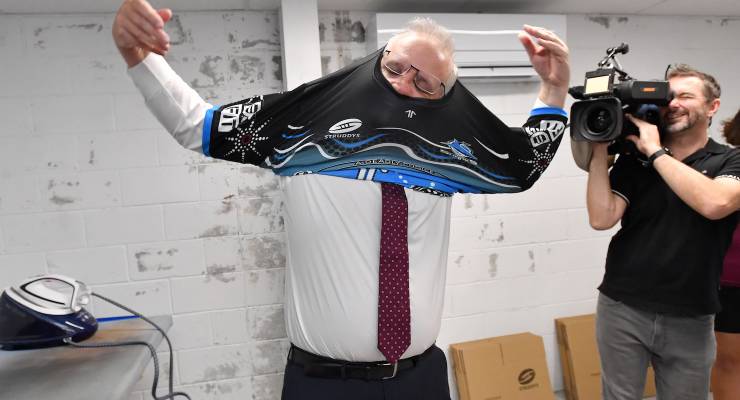 Scott Morrison trying on a Cronulla-Sutherland Sharks jersey (Image: AAP/Darren England)