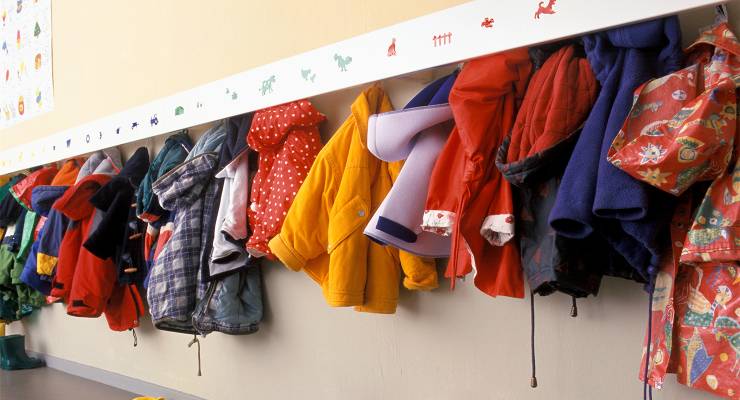 Children's coats hanging at a childcare centre (Image: Adobe)
