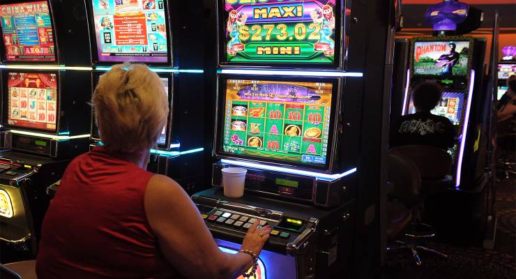 People playing poker machines in Brisbane, Thursday (Image: AAP/Dan Peled)
