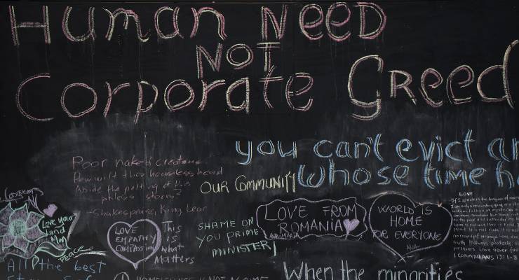 A protest sign outside the RBA building in Sydney (Image: AAP/Dean Lewins)