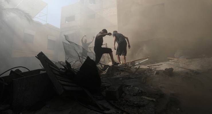 Palestinians look for survivors under the rubble of a destroyed building (Image: AP Photo/Mohammed Dahman)