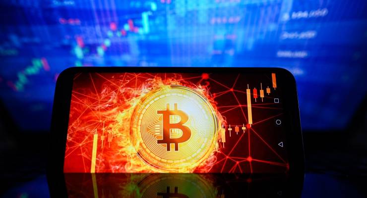 The Bitcoin logo displayed on a smartphone with sharemarket percentages in the background (Image: SOPA Images/Sipa USA/Omar Marques)