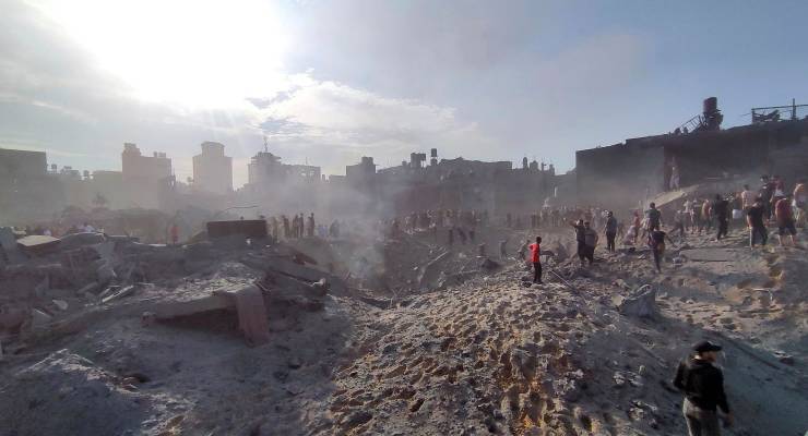 Palestinians inspect the damage of buildings destroyed by Israeli airstrikes (Image: AAP/Abdul Qader Sabbah)