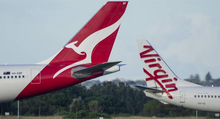 Qantas and Virgin passenger jets taxiing at Sydney Airport (Image: AP/Mark Baker)