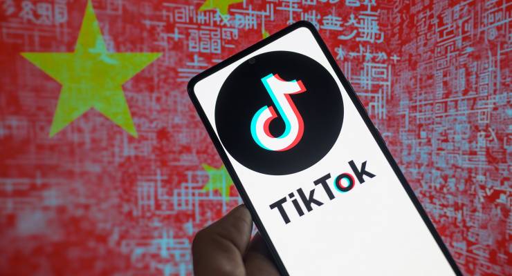 The TikTok logo on a smartphone against a graphic depicting the Chinese flag (Image: Jonathan Raa/SIPA USA)