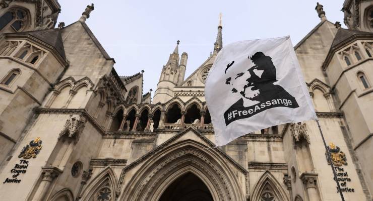 A flag depicting Julian Assange hangs outside London's Royal Courts of Justice (Image: EPA/Neil Hall)